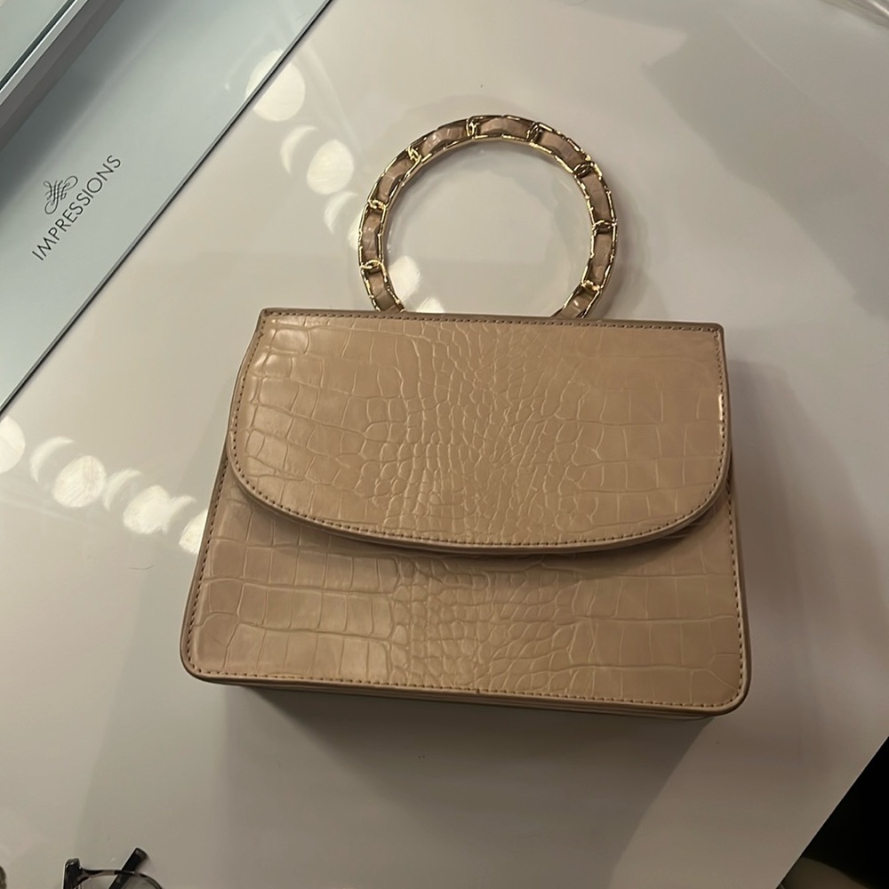 Like dreams clutch with chain crossbody strap.